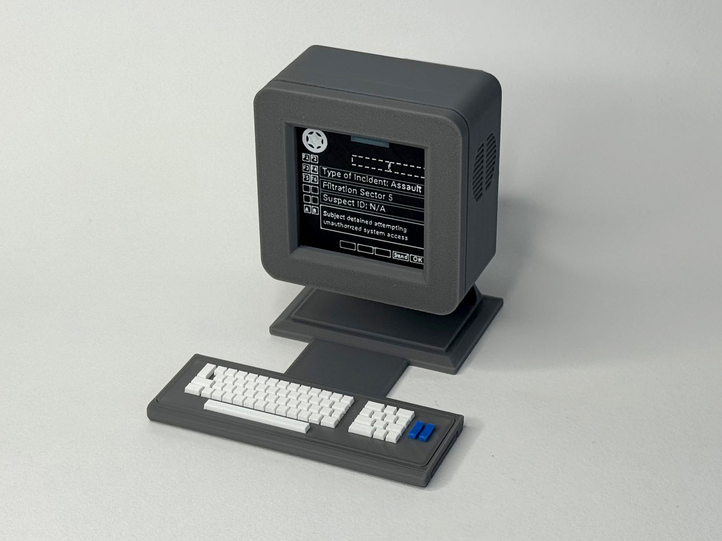 Vintage computer monitor and keyboard on a light gray background