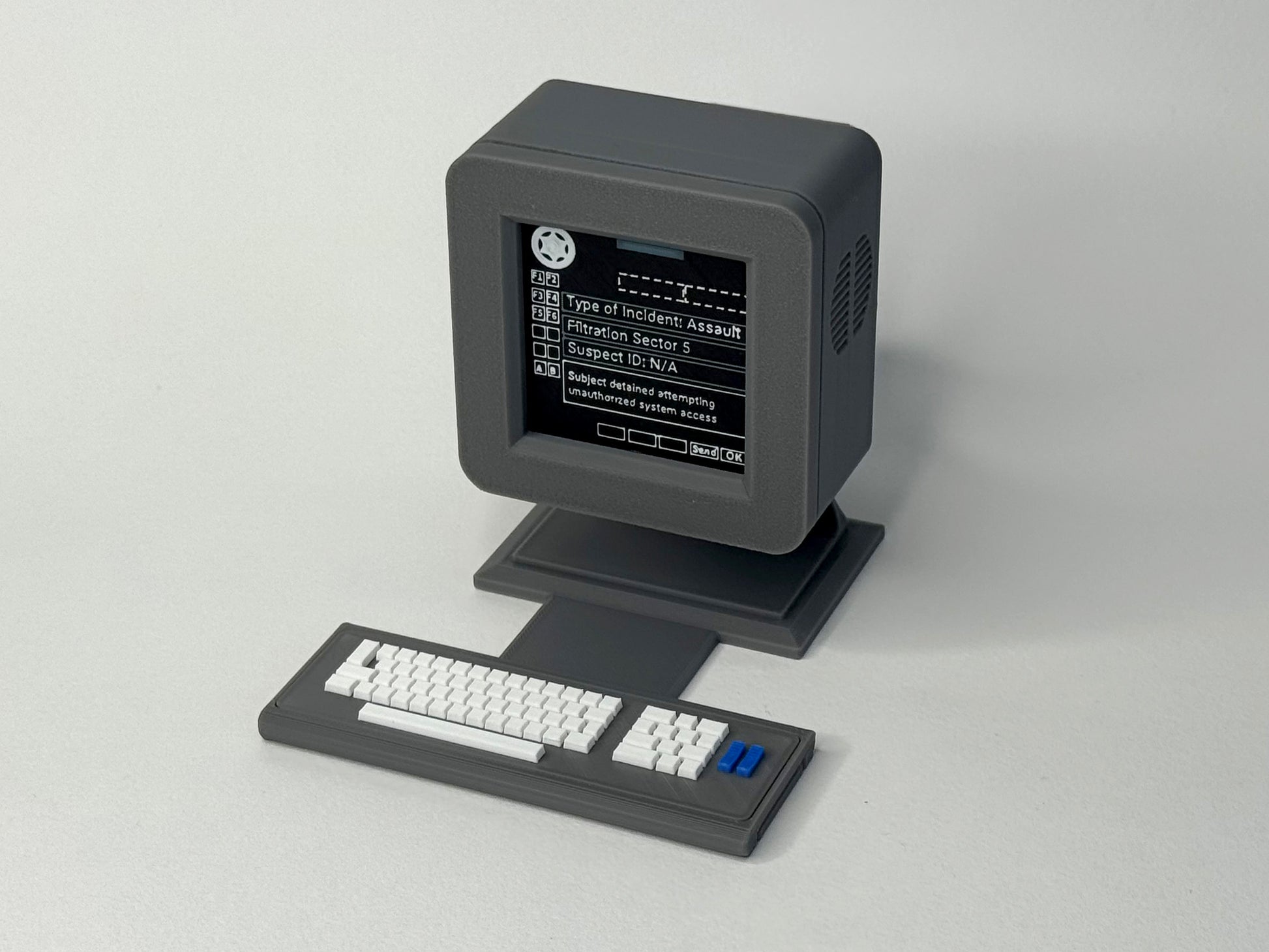 Vintage computer monitor and keyboard on a light gray background